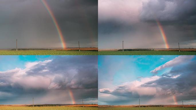 雨中充满戏剧性的天空，地平线上有彩虹。农业和天气预报概念。延时，延时，延时。秋季雨天的乡村草地