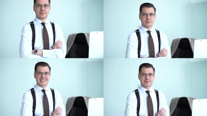 自信快乐的商人戴着眼镜在办公室看着相机，积极的男性员工高管笑脸满足于在现代办公室摆姿势好的工作生涯。