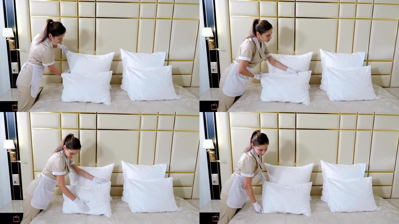 酒店清洁概念。穿着制服的年轻漂亮女仆的肖像在明亮的房间里铺床，触摸枕头，打成形状。准备酒店房间。4 