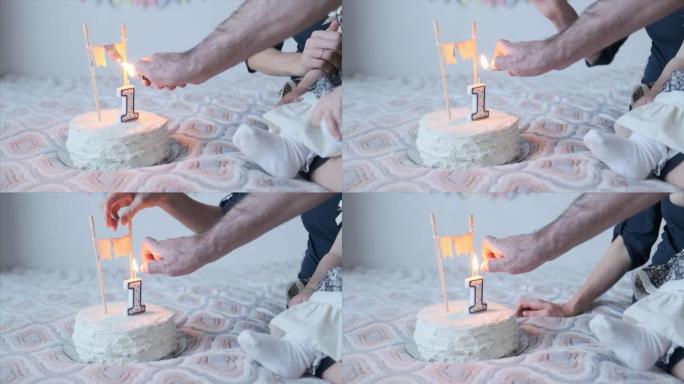 母亲向女儿展示第一个生日蛋糕，然后男人在家里庆祝时点燃蜡烛