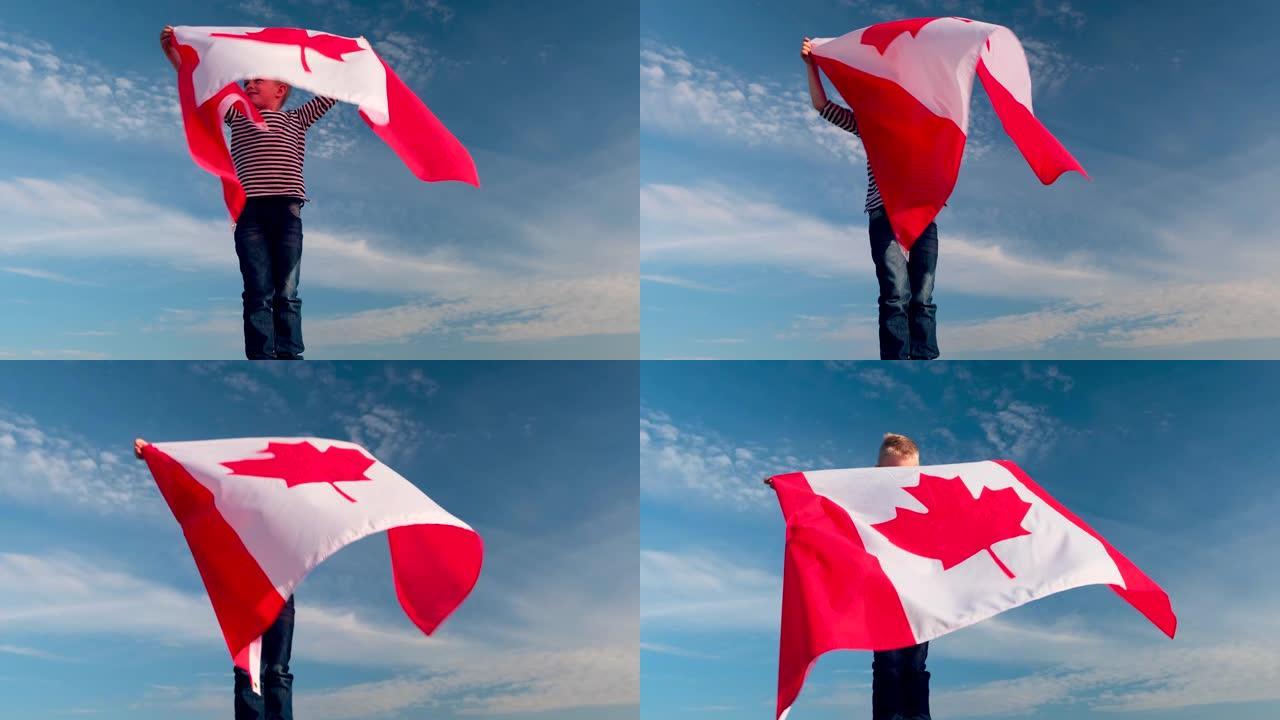 4k。夏天，金发男孩在蓝天上户外挥舞加拿大国旗 -- 加拿大日，国家，爱国主义，独立日7月1日