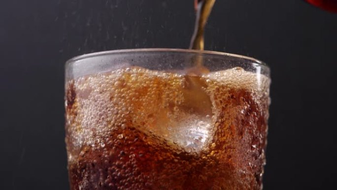 一杯可乐。将可乐倒入加冰的玻璃杯中。用碳酸可乐填充玻璃