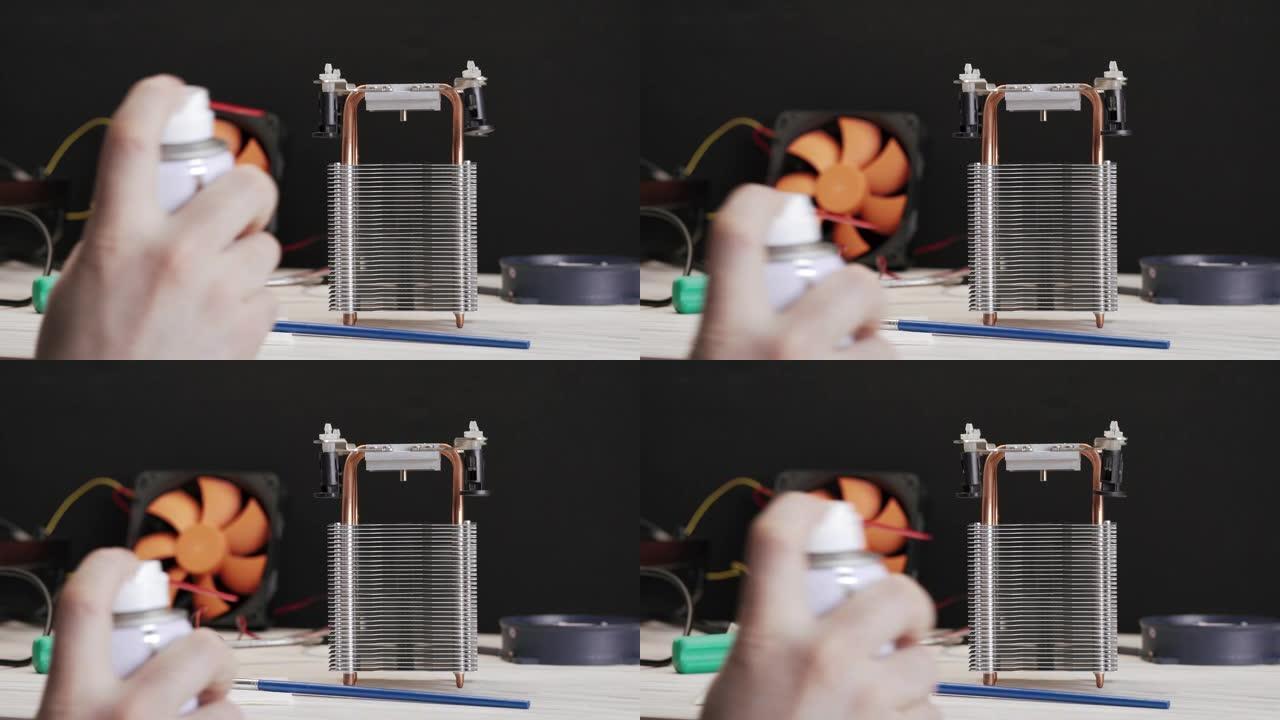 电脑CPU散热散热器的特写清理服务人员用一罐压缩空气清除灰尘。服务清洁计算机。