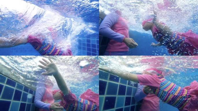 快乐的亚洲小女孩在夏天和她的母亲在游泳池里玩耍。度假中的家庭生活方式。
