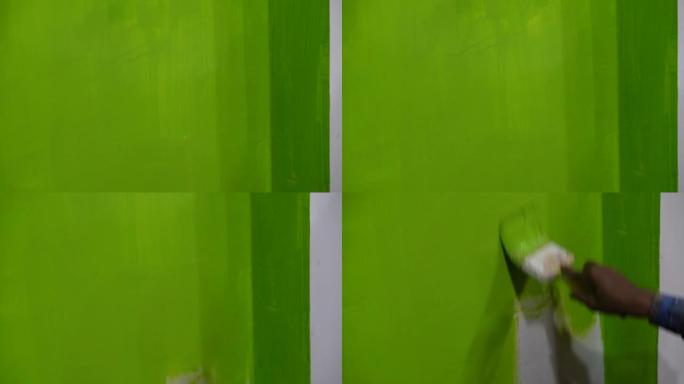 男人在墙上画绿色