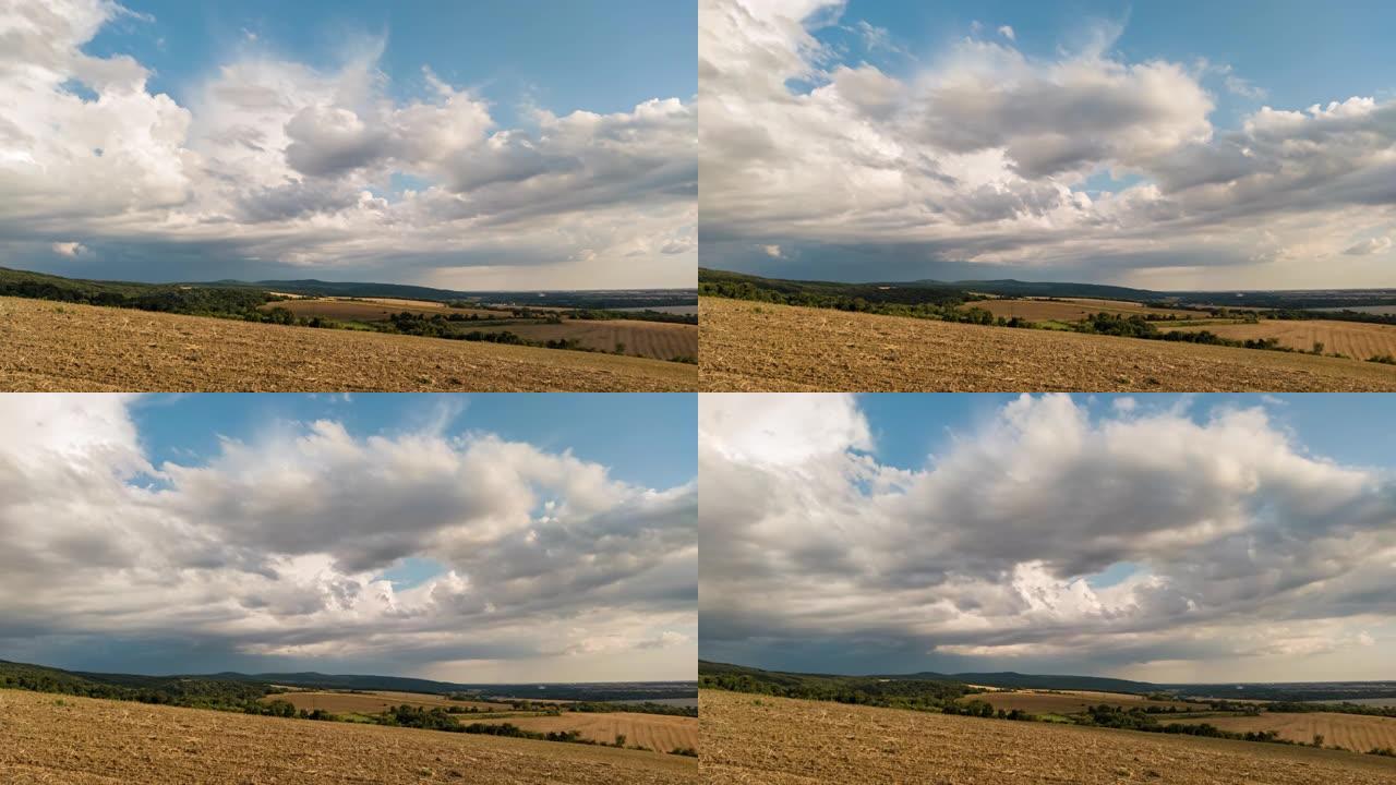 雨云在乡村丘陵和麦田上空移动的时间流逝
