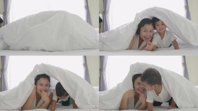 母亲和儿子之间的亚洲家庭在早晨，自然的光线下快乐地在一起捉迷藏。4k慢动作