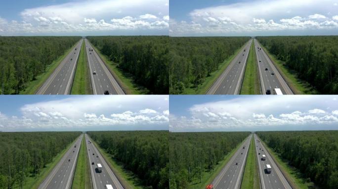 绿树环绕的多车道道路，灰蒙蒙的天空下缩小绿色树林