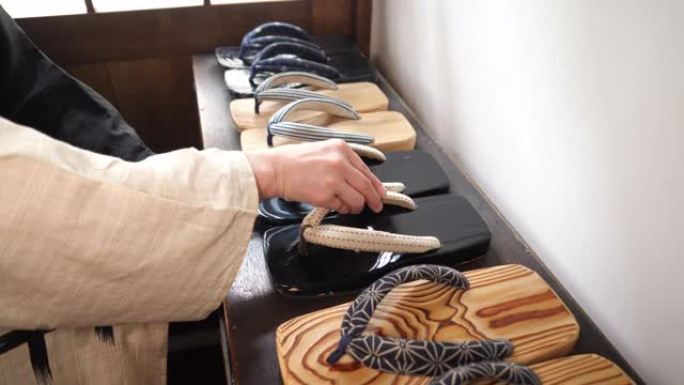 日本妇女在旧日本日式旅馆里拿起日本zori geta凉鞋