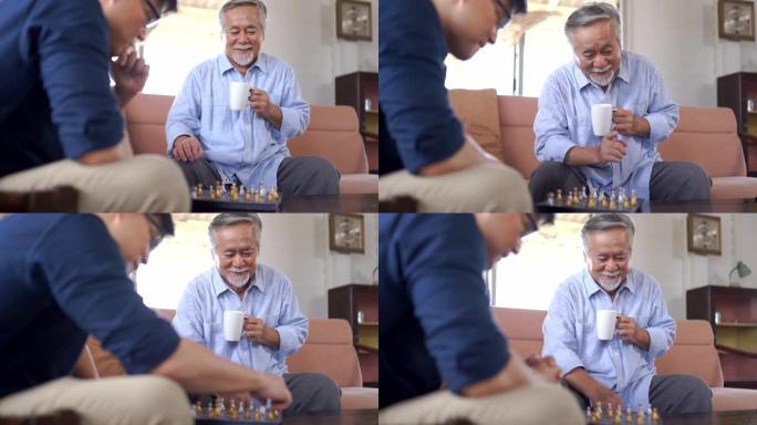 亚洲资深男子在家与儿子下棋