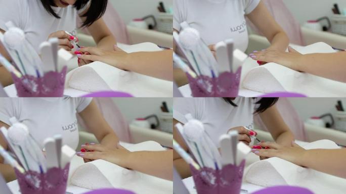 专业美容师在美甲沙龙画女性指甲