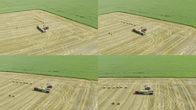 装载机的空中僵尸平移镜头将干草堆放入卡车后部。在村子里收割。夏季的农业概念。