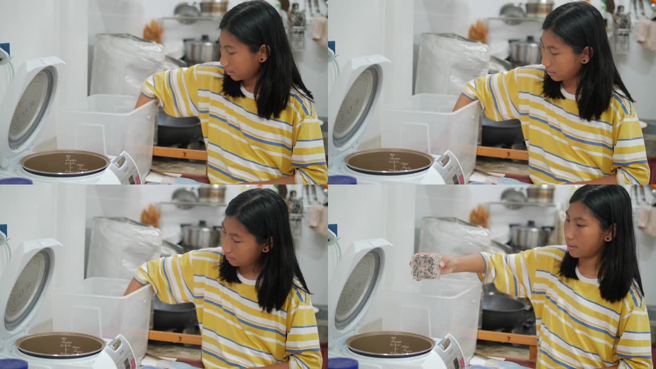 亚洲女孩在家厨房煮饭，女孩帮妈妈准备食物。