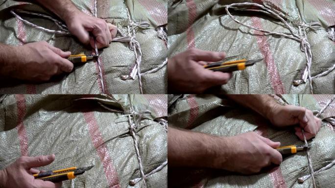 男性手用刀割断绳索的4k视图