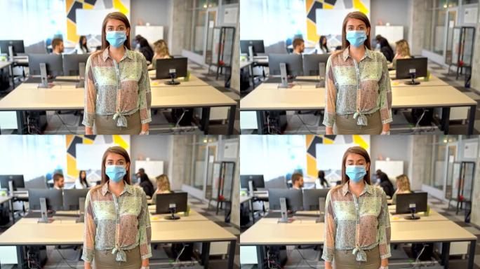 我要赢得胜利-自信的女商人在办公室里戴着防护口罩，看着镜头