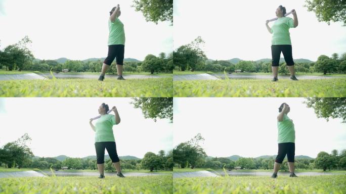 亚洲胖乎乎的高级女性在公园做站立热身运动，湖山翻身臀部充分伸展，退休后生活自理动力，保健理念，宽镜头