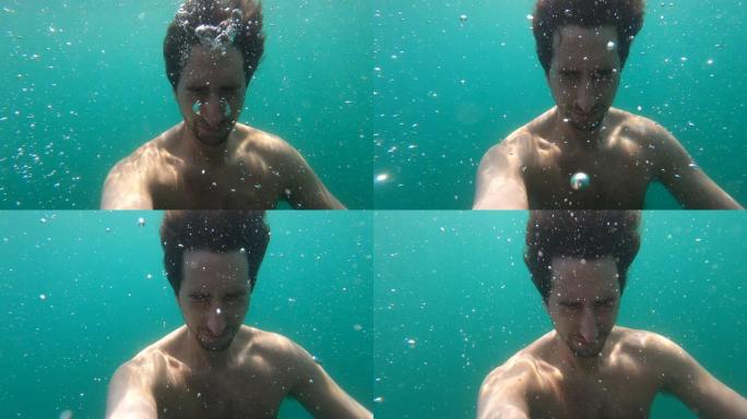 水下的人屏住呼吸。水下的肖像脸