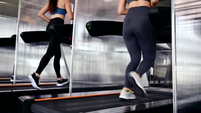 运动女性在跑步机上锻炼和跑步。亚洲女性在健身馆锻炼和生活方式。健美健康。