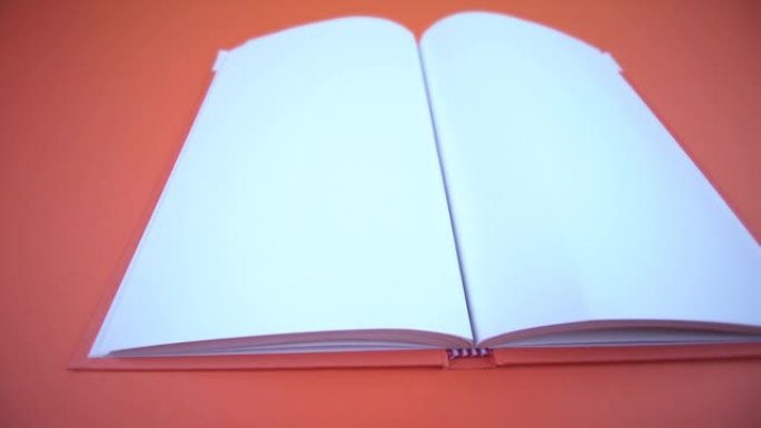 打开橙色背景上有空页的书