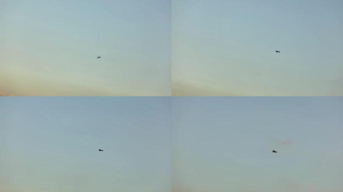 空中无人机在美丽的云彩背景下。彩色天空背景上的军用无人机