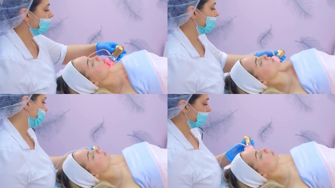 美容师医生在女人脸上做语音电泳手术，侧视图。