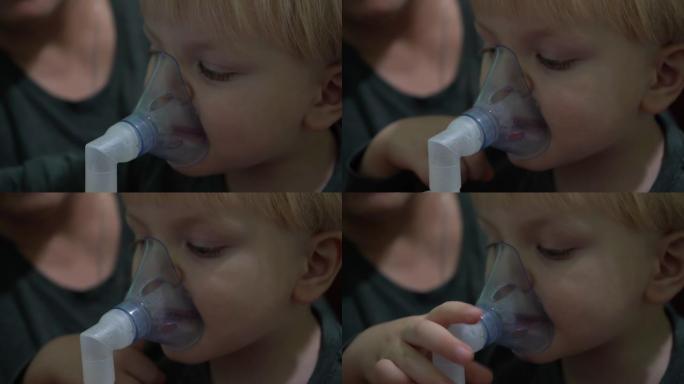 一个三岁的孩子戴着氧气面罩呼吸。吸入呼吸道。面罩吸入器。