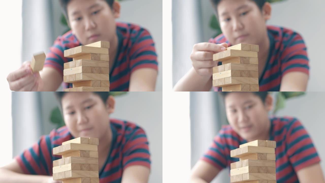亚洲儿童在家里的地板上一起玩木块拆卸游戏，生活方式理念。