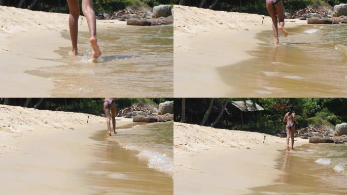 软焦点和焦点拍摄女子的腿在沙滩水边奔跑。