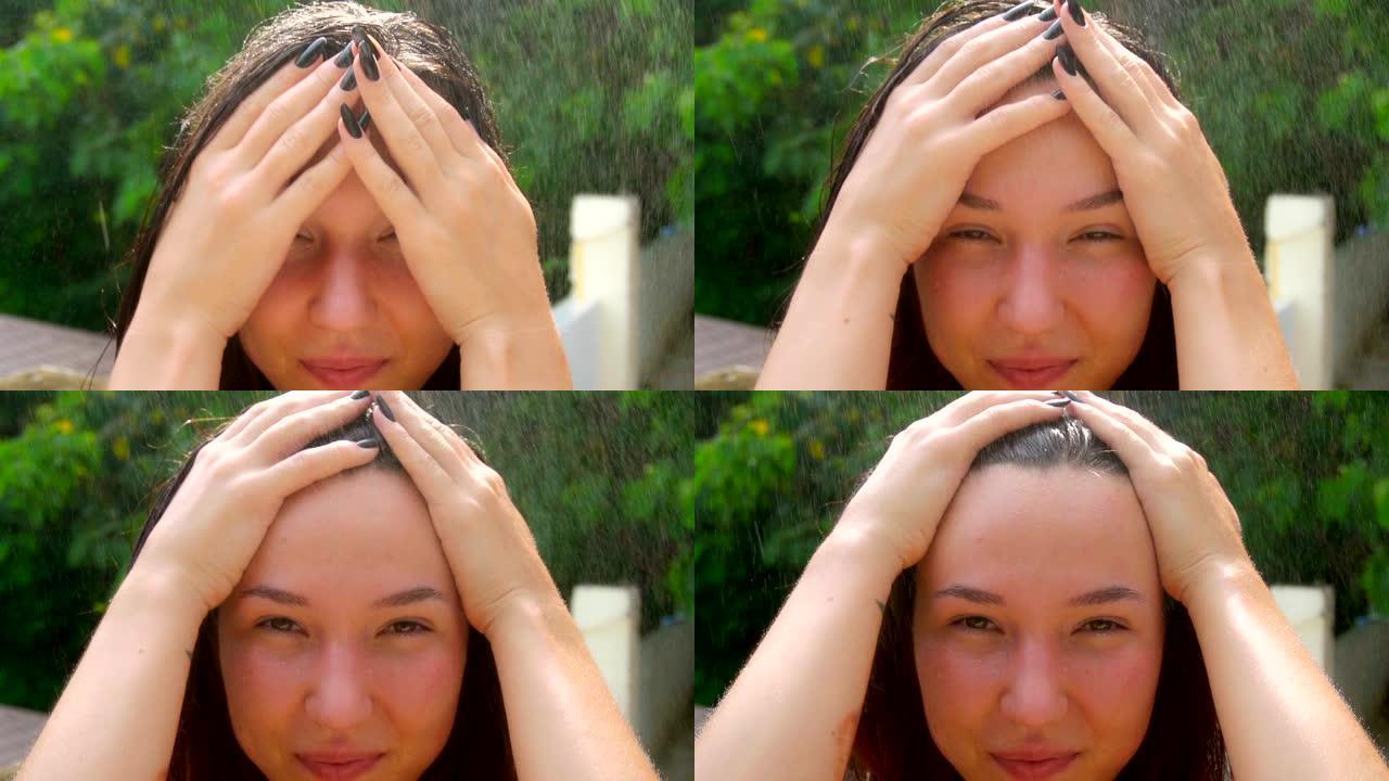 一个年轻的女人在雨中。一个女人从脸上去除湿头发