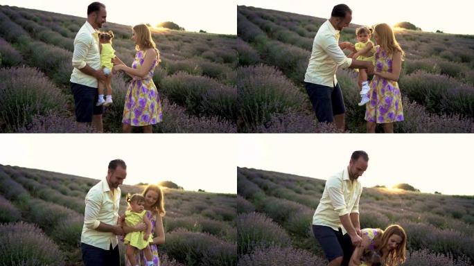 幸福的家庭妈妈，爸爸和女儿在薰衣草地里玩得开心