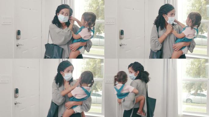 小女孩帮助妈妈在离开家时戴上防护口罩