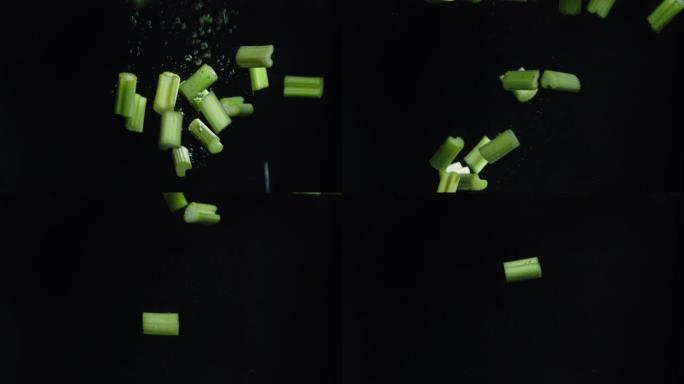 芹菜碎片随着气泡落入水中。