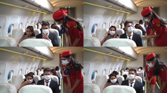 坐在飞机椅子上后戴着口罩的商人。女乘务员或乘务员正在步行并检查飞机上的乘客座椅和设备。