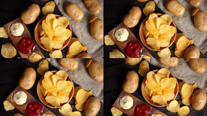 不同酱汁的薯条和新鲜的土豆慢慢旋转。