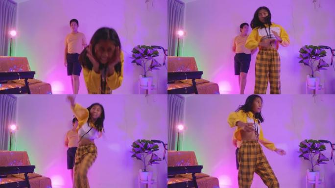快乐的亚洲孩子在房子的派对上一起跳舞，用发光二极管灯，生活方式概念。