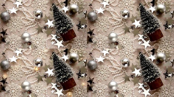 圣诞玩具、玩具圣诞树、雪花、银星、珍珠珠子和闪光花环在灯光背景上。圣诞节和新年背景。圣诞快乐，新年快