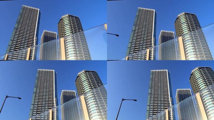 蓝天背景下的现代高层公寓楼。平移镜头。