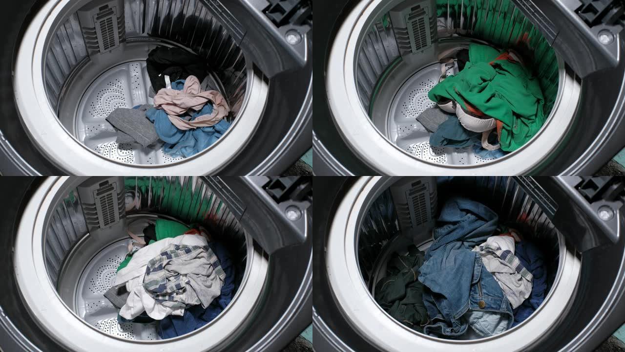 人们正在把他们用过的衣服放在洗衣机里。
