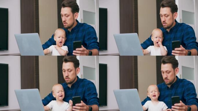 年轻的大胡子男人坐在家里的桌子上，拿着笔记本电脑，膝盖抱着可爱的婴儿，用键盘书写，在智能手机上阅读信