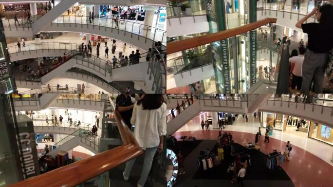 自动扶梯的时间流逝，人们在购物中心的一个大圆广场上经过。