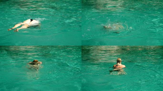 穿着泳衣的女人潜入水中，在希腊的海里游泳。慢动作。高清