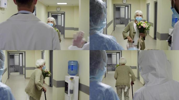 戴医用口罩的高级女患者手持鲜花出院