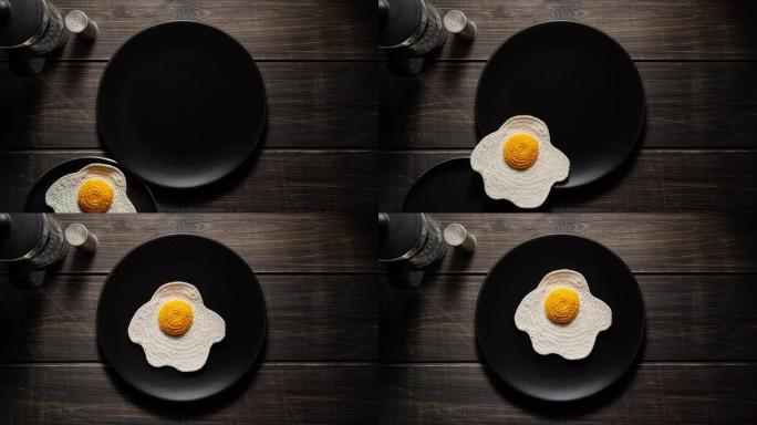 针织煎蛋放在盘子里。合成食品。停止运动。顶视图。