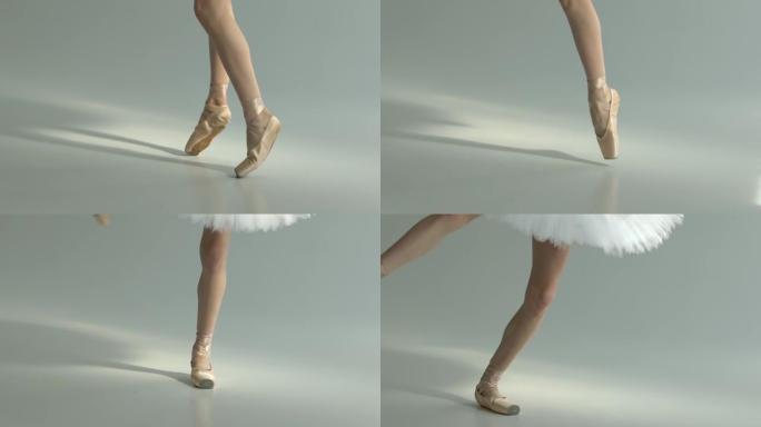 穿着尖头鞋的细长balarina腿执行旋转运动。迷人的舞蹈。白色背景。特写。慢动作