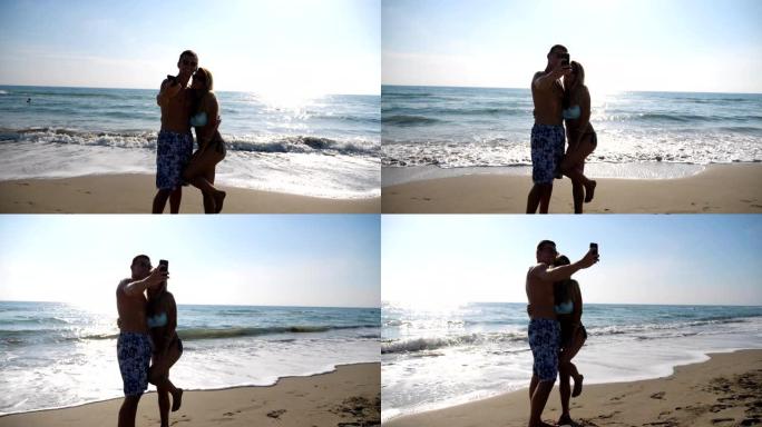 微笑的夫妇在海岸摆姿势自拍。快乐的旅行对在海边摄影。快乐的新婚夫妇享受度假胜地的蜜月。风景秀丽的海景