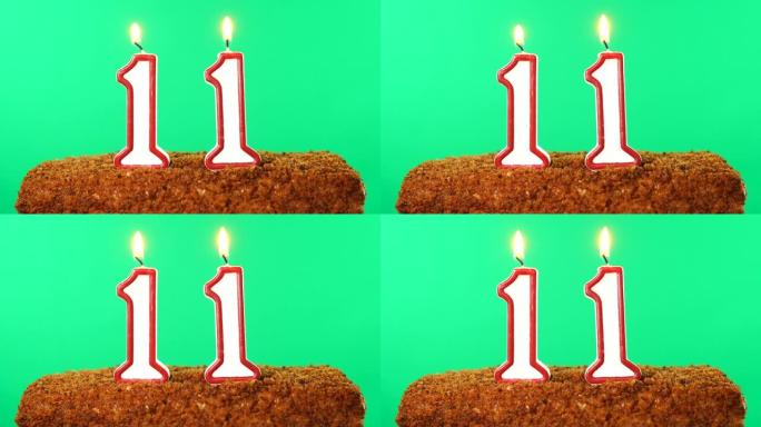 用11号点燃的蜡烛蛋糕。色度键。绿屏。隔离