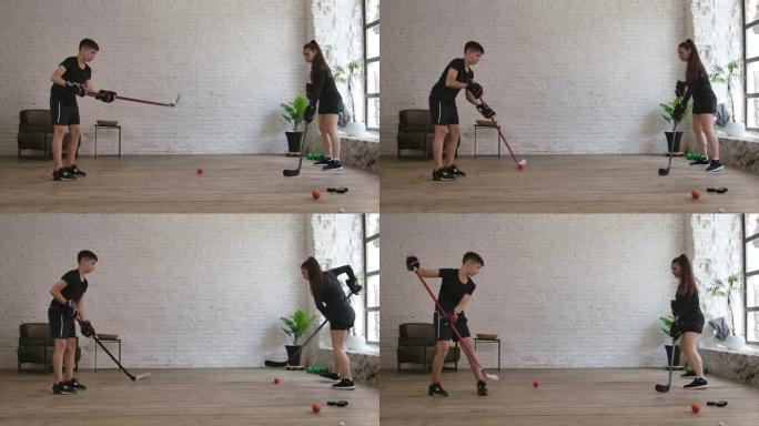 男孩曲棍球训练与教练女子在室内。慢动作