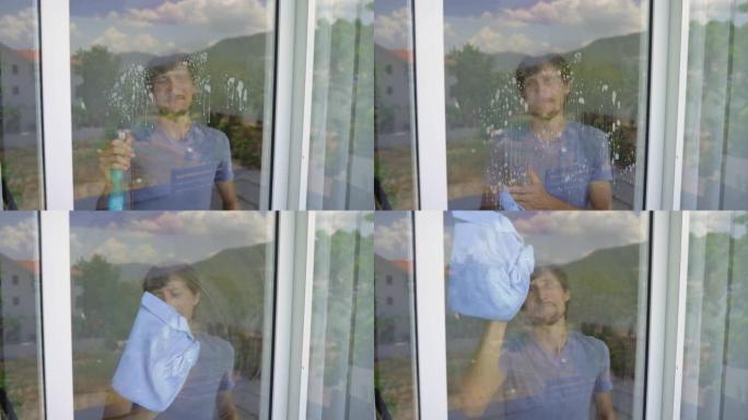 一个年轻人用玻璃清洗液清洗玻璃门。性别平等