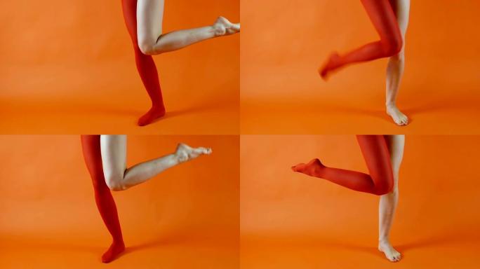 女模特在明亮的橙色背景下，一条腿上穿着红色紧身衣，另一条腿赤裸，没有丝袜。