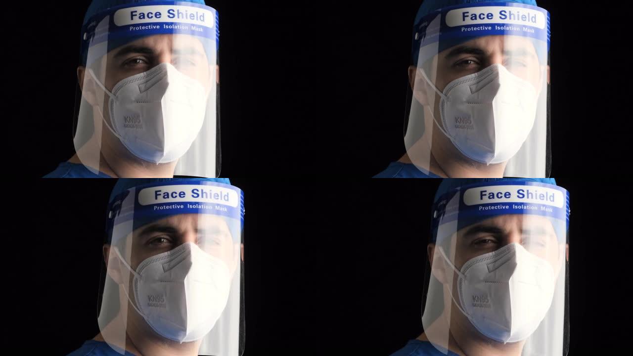 沉思疲倦的年轻男性医护人员看着戴着n95防护面罩和面罩的相机